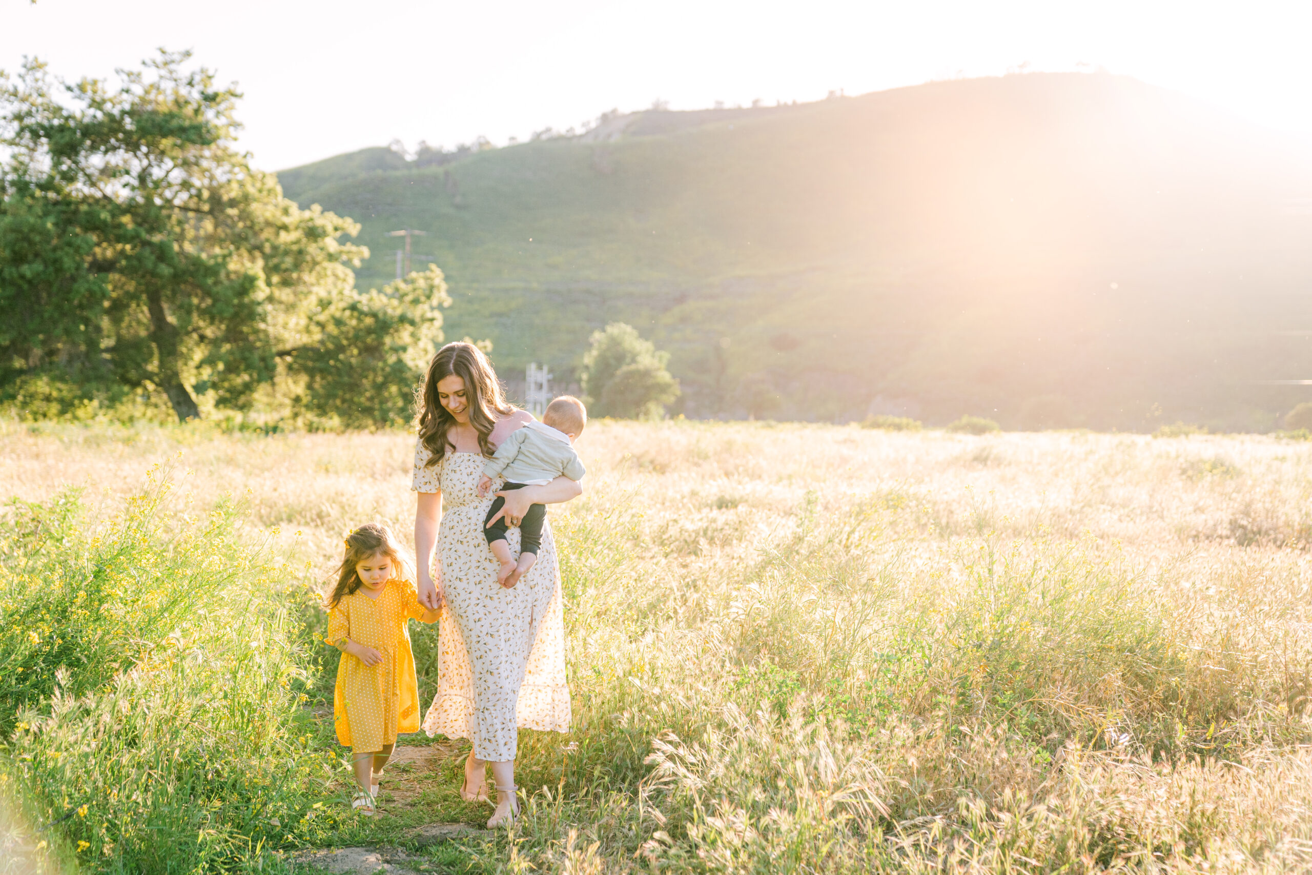 Family photos in yellow wildflowers located in San Juan Capistrano, California. Photos by Kate Noelle.